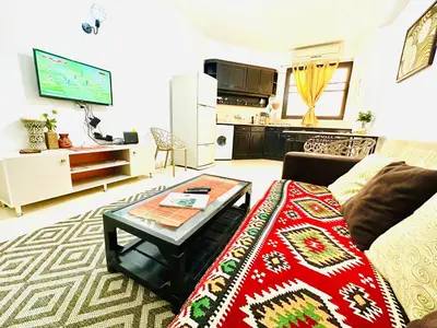 a living room with a couch and a table at Tamburine Chalet with Wi Fi Hurghada center in Hurghada