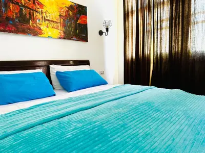 a bed with blue pillows in a bedroom at Tamburine Chalet with Wi Fi Hurghada center in Hurghada