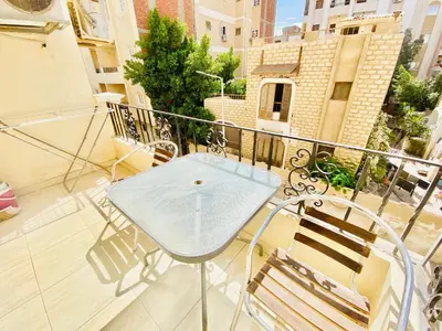 a balcony with a blue table and chairs at Panda Grey with balcony Hurghada center in Hurghada