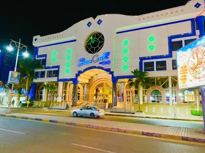 a car parked in front of a building at night at Panda Grey with balcony Hurghada center in Hurghada