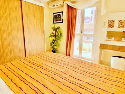 a bedroom with a large bed and a window at Panda Grey with balcony Hurghada center in Hurghada