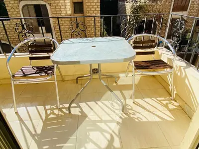 a blue table and two chairs on a balcony at Panda Grey with balcony Hurghada center in Hurghada