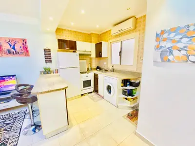 a kitchen with a white refrigerator and a dishwasher at Panda Grey with balcony Hurghada center in Hurghada