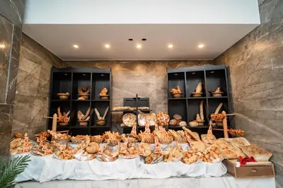 a display of bread and pastries on a table at Sphinx Aqua Park Beach Resort in Hurghada