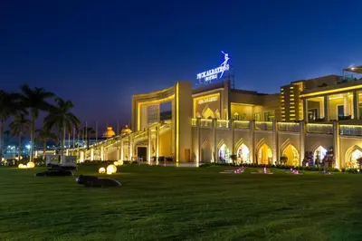 a building with a lawn in front of it at night at Pickalbatros Aqua Blu Resort - Hurghada in Hurghada
