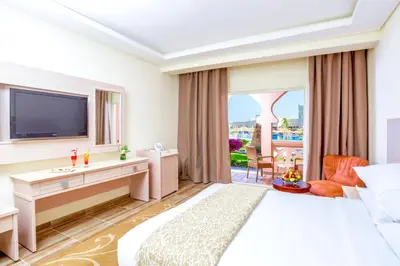 a hotel room with a bed and a television at Pickalbatros Aqua Blu Resort - Hurghada in Hurghada