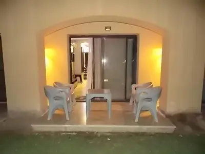 a group of white chairs sitting in a room at Sea View Duplex Villa in Hurghada