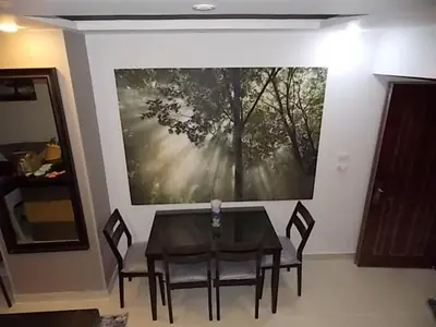 a table and chairs in a room with a painting on the wall at Sea View Duplex Villa in Hurghada