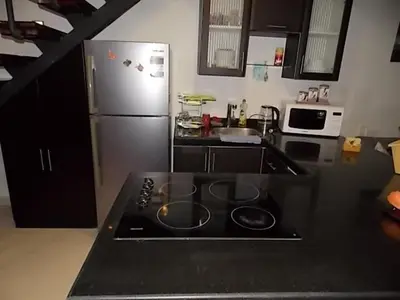 a kitchen with a stove and a refrigerator at Sea View Duplex Villa in Hurghada