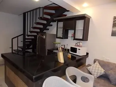 a kitchen with a black counter top and a staircase at Sea View Duplex Villa in Hurghada