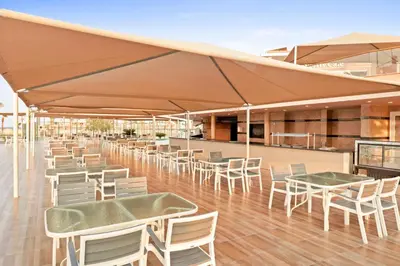 a restaurant with tables and chairs under a tent at Pickalbatros Aqua Park Resort - Hurghada in Hurghada