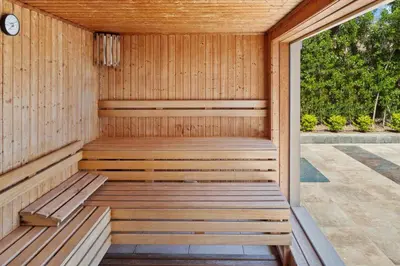 a wooden sauna with a wooden bench in a room at Pickalbatros Aqua Park Resort - Hurghada in Hurghada