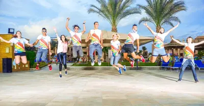 a group of people jumping in the air at Pickalbatros Aqua Park Resort - Hurghada in Hurghada
