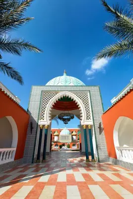 an entrance to a mosque with a blue sky at Pickalbatros Alf Leila Wa Leila Resort - Neverland Hurghada in Hurghada