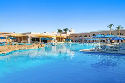 a large pool with blue water in a resort at Pickalbatros Alf Leila Wa Leila Resort - Neverland Hurghada in Hurghada