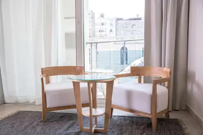 two chairs and a table in a room with a window at Redcon Suites in Hurghada