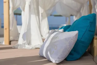 a white pillow sitting on a bed under a canopy at Redcon Suites in Hurghada