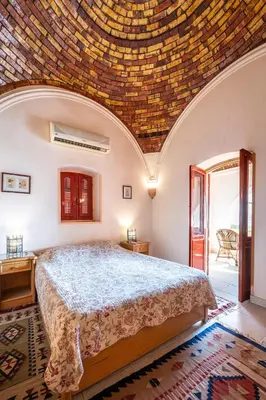 a bedroom with a bed with a brick ceiling at villa al diwan luxor in Luxor