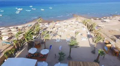 an aerial view of a beach with umbrellas and the ocean at Lagoonie Lodge & Beach in Hurghada