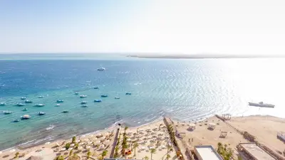 an aerial view of a beach with umbrellas and boats at Lagoonie Lodge & Beach in Hurghada