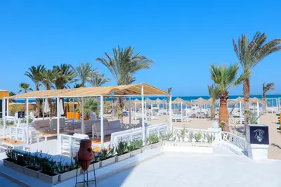 a view of a resort with palm trees and the ocean at Lagoonie Lodge & Beach in Hurghada