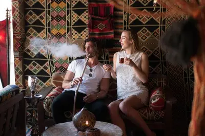 a man and a woman sitting on a couch with a microphone at Sunrise Mamlouk Palace Resort in Hurghada