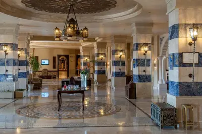 a lobby with a table in the middle of a building at Sunrise Mamlouk Palace Resort in Hurghada