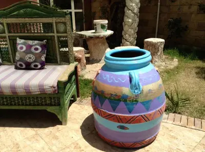 a large colorful vase sitting next to a chair at Diamond Arabia with Wi Fi in Hurghada
