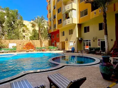 a swimming pool in the middle of a building at Diamond Arabia with Wi Fi in Hurghada