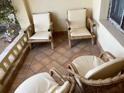 two chairs sitting on a porch next to a window at El Gouna 1 Bedroom Apartment west golf ground floor in Hurghada