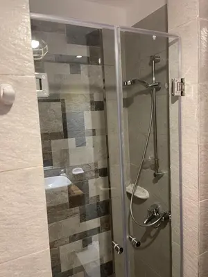 a bathroom with a glass shower with a sink at El Gouna 1 Bedroom Apartment west golf ground floor in Hurghada