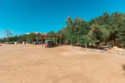 a dirt parking lot with a pavilion and trees at El Gouna 1 Bedroom Apartment west golf ground floor in Hurghada