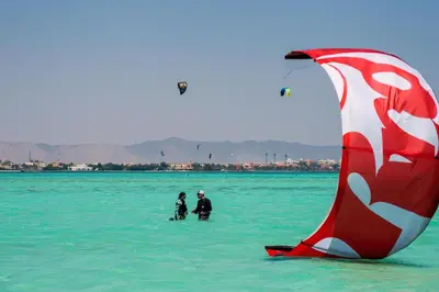 two people in the water with a kite in the water at Mosaique Hotel El Gouna in Hurghada