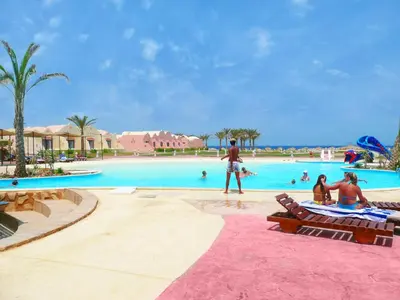 a group of people in a swimming pool at a resort at ONATTI Beach Resort - Marsa Alam in Quseir