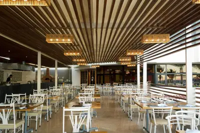 a dining room with white tables and white chairs at Sunrise Holidays Resort -Adults Only in Hurghada