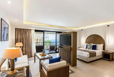 a hotel room with a bed and a television at Sunrise Holidays Resort -Adults Only in Hurghada