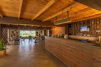 a restaurant with a bar with tables and chairs at Meraki Resort - Adults Only in Hurghada