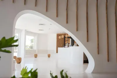 an archway leads into a white room with a wine cellar at Meraki Resort - Adults Only in Hurghada