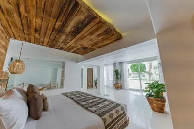 a bedroom with a large bed with a wooden ceiling at Meraki Resort - Adults Only in Hurghada