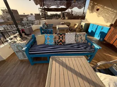 a blue bench sitting on top of a balcony at House of Dreams apartments Luxor in Luxor