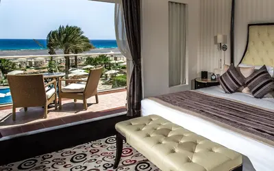 a hotel room with a bed and a view of the ocean at Premier Le Reve Hotel & Spa Sahl Hasheesh - Adults Only 16 Years Plus in Hurghada