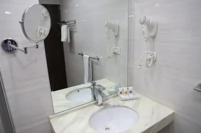 a bathroom with a sink and a mirror at Aswan Plaza Hotel in Aswan