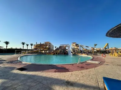 a pool with a water slide in a resort at Comfortable studio in hotel Karma with private beach and pools family only or female in Hurghada