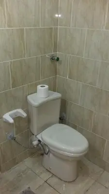 a bathroom with a toilet with a roll of toilet paper at tiba resort hurghada A16 in Hurghada