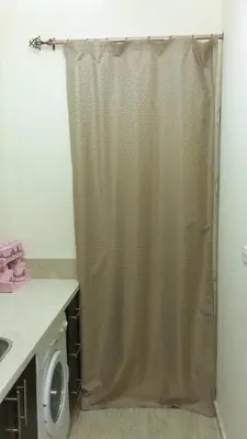 a shower curtain in a bathroom with a washing machine at tiba resort hurghada A16 in Hurghada