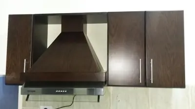 a kitchen with a extractor hood and wooden cabinets at tiba resort hurghada A16 in Hurghada