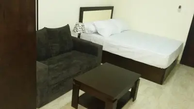 a bedroom with a bed and a couch and a chair at tiba resort hurghada A16 in Hurghada