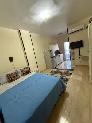 a bedroom with a blue bed in a room at Cozy little studio near Kite station. in Hurghada
