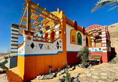 a colorful building in the middle of the desert at Kato Dool Wellness Resort in Aswan