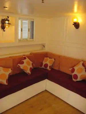 a couch with pillows on it in a room at felouque avec toilettes in Aswan
